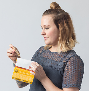 Woman holding box of condoms.