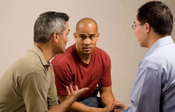 A group of men sitting and talking