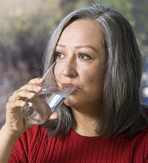 Woman drinking a glass of water.